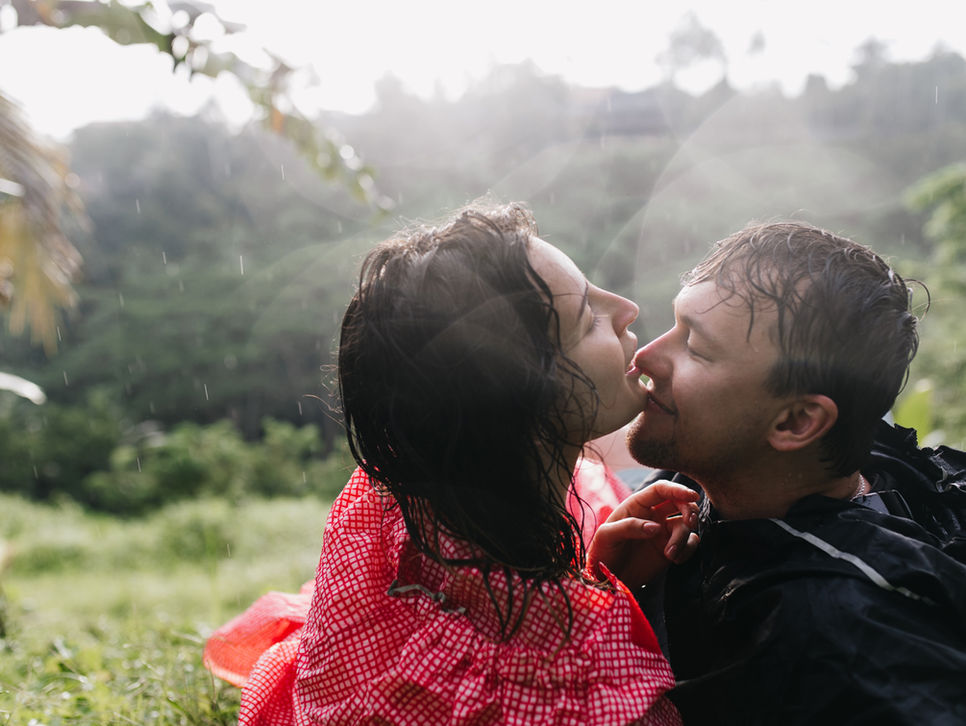 A couple sharing a close, intimate moment outdoors