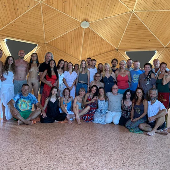 Andrew with a group in a wooden hall
